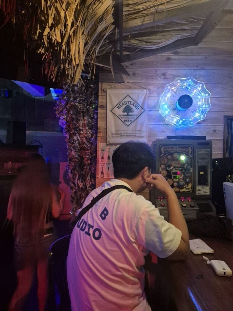 DNA MUSIC BAR 안의 레트로 게임기와 네온 장식